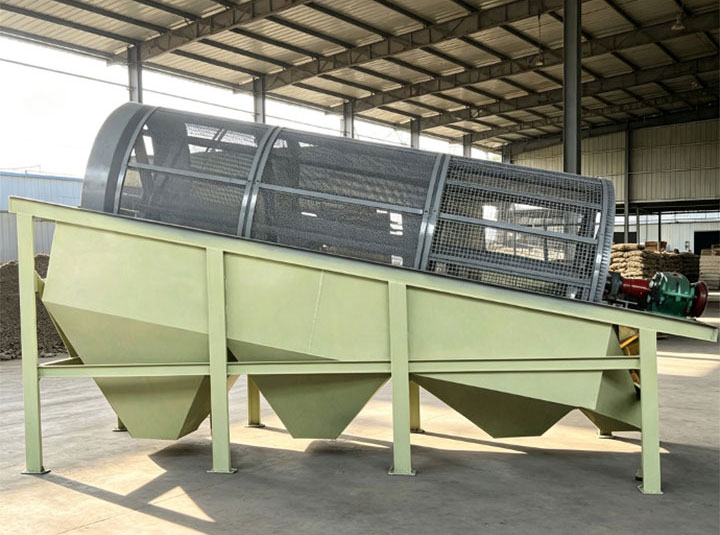 Light green trommel screen for topsoil processing, featuring a rotating cylindrical drum and multiple discharge hoppers, ideal for damp, cohesive compost and wet soil.