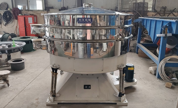 Stainless steel tumbler screening machine with multiple screen decks and side discharge outlets.